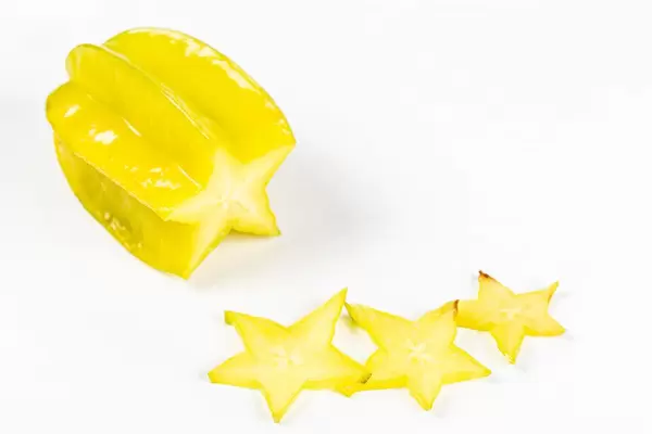 Fresh carambola or star fruit with slices on white background