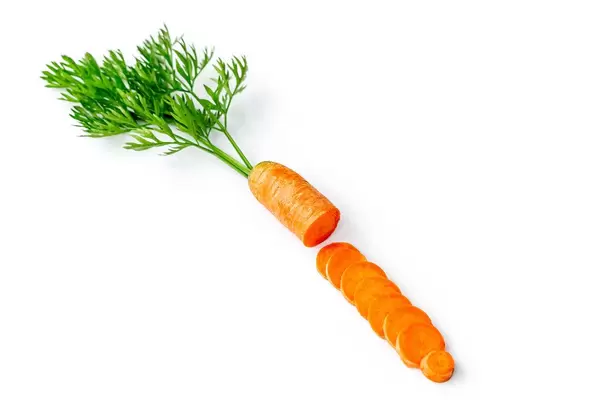 Fresh carrot slices with green leaves on white background