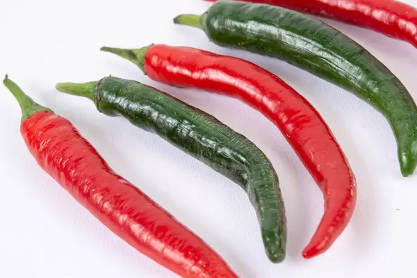 Fresh Chilli Red and Green Hot Peppers isolated above white background (Flip 2019)
