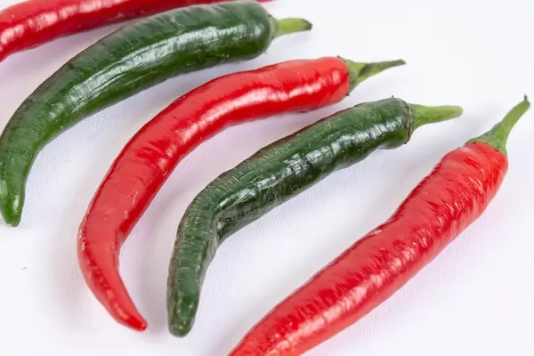 Fresh Chilli Red and Green Hot Peppers isolated above white background