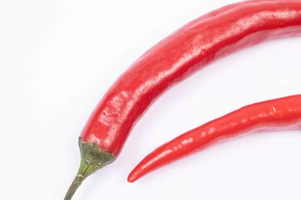 Fresh Chilly Red Hot Peppers above white background