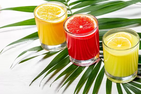 Fresh citrus juices with green leaf (Flip 2019)