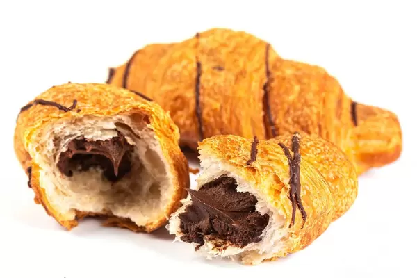 Fresh croissant with chocolate filling on white background