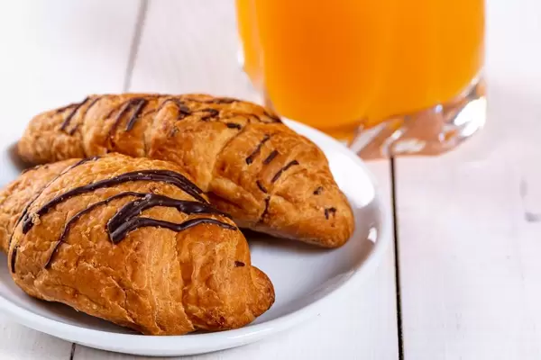 Fresh croissants with orange juice