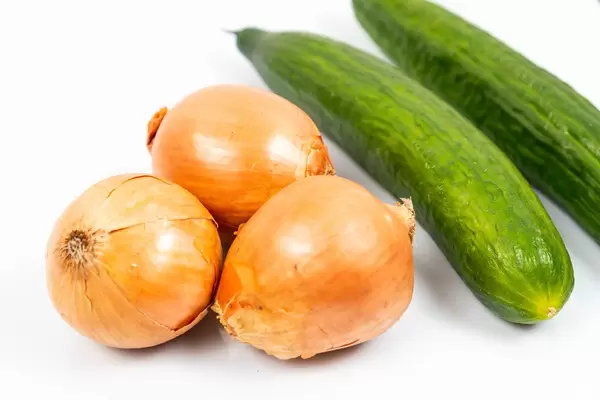Fresh Cucumbers and Onions on the white table (Flip 2020)