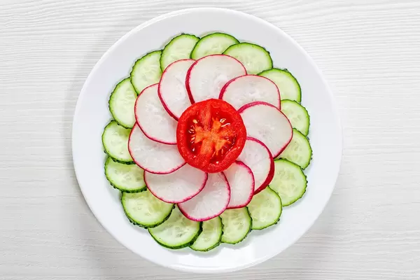 Fresh diet salad of cucumber, radish and tomato. Top view