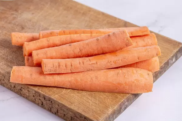 Fresh Domestic Carrots sliced on the wooden board