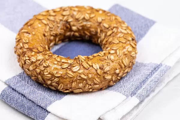 Fresh Donut with Olives on the kitchen tablecloth