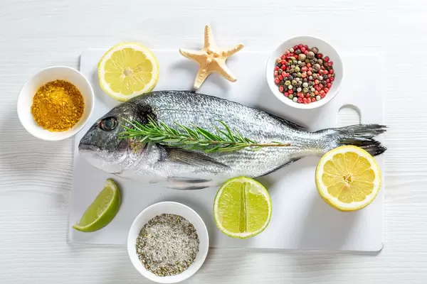 Fresh Dorada with lime, lemon, spices and starfish. Top view (Flip 2019)