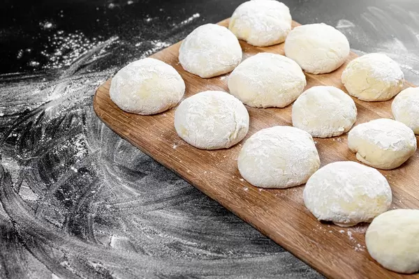 Fresh dough on a wooden kitchen Board (Flip 2019)