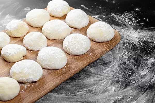 Fresh dough on a wooden kitchen Board