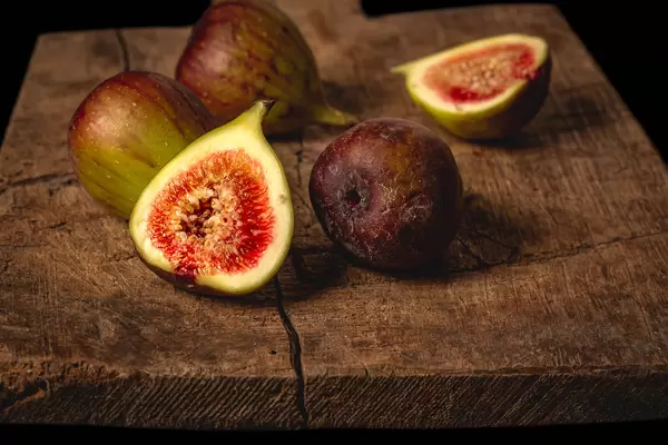 Fresh figs on an old wooden background
