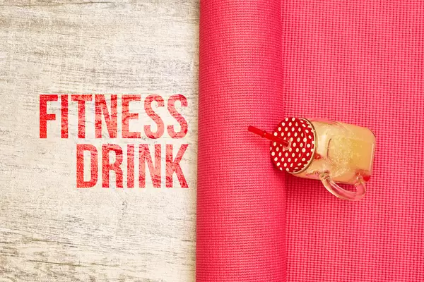 Fresh fitness drink smoothie on yoga mat