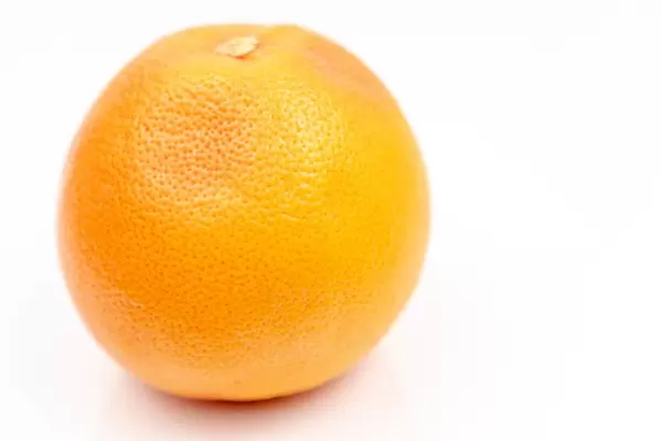 Fresh Grapefruit on the white reflective surface with copy space (Flip 2020)