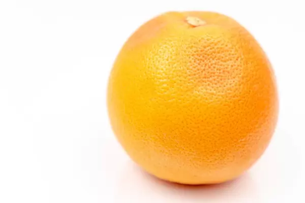 Fresh-Grapefruit-on-the-white-reflective-surface-with-copy-space.jpg