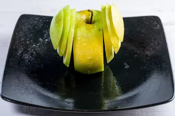 Fresh green Apple sliced on a plate (Flip 2019)