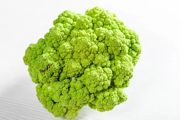 Fresh green broccoli on light wooden background (Flip 2019)