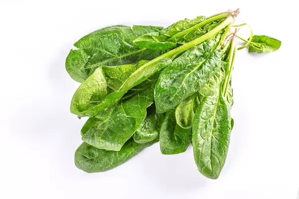 Fresh green spinach on a white background