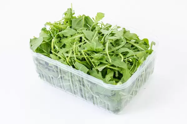 Fresh Healthy Green Rucola in the box above white background (Flip 2019)