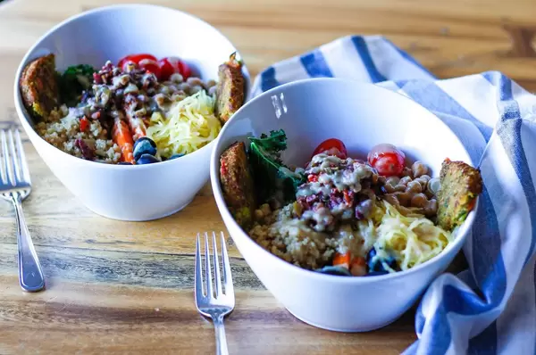 Fresh Healthy Salad With Quinoa, Tomatoes, Olives and Dressing