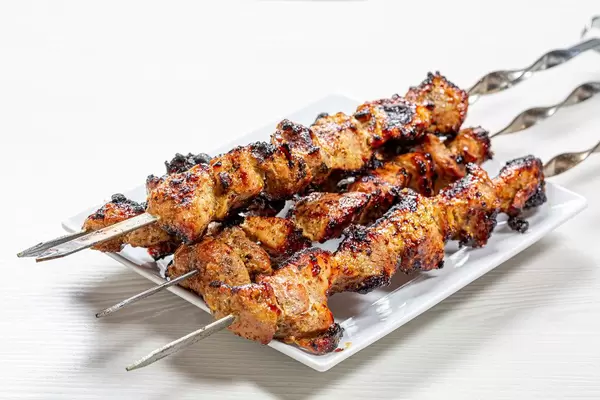 Fresh, home-cooked on the grill fire barbecue pork with skewers