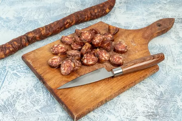 Fresh homemade Sausage sliced on the wooden board