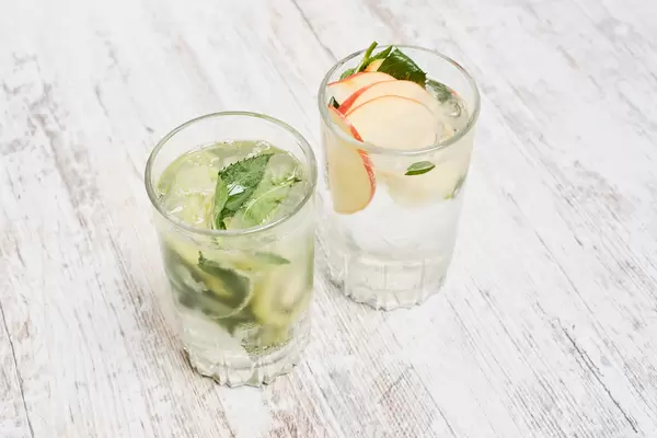 Fresh iced fruit drinks on wooden background