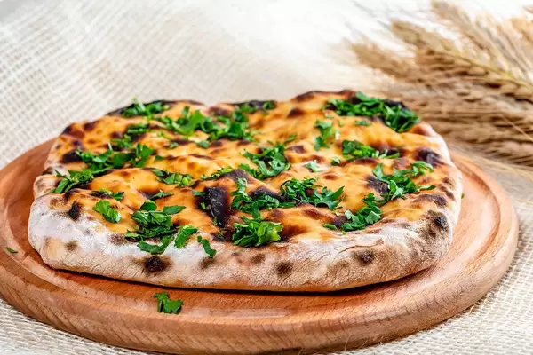 Fresh khachapuri with cheese on burlap (Flip 2019)