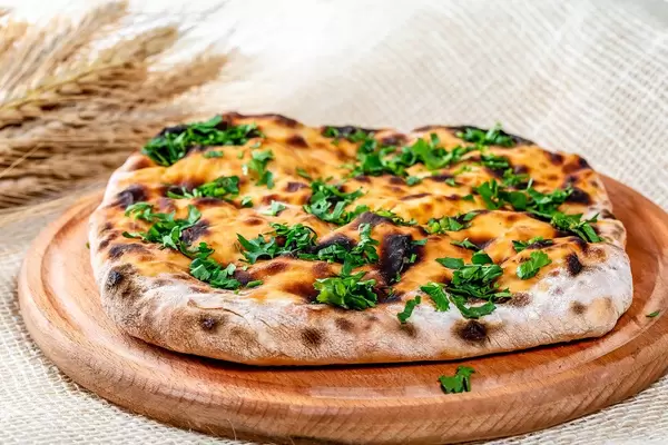 Fresh khachapuri with cheese on burlap