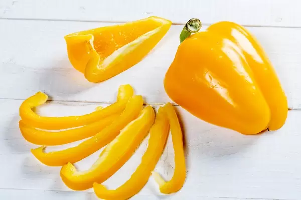 Fresh orange bell pepper on a white wooden background  Flip 2019