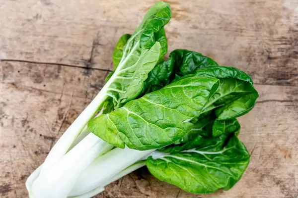 Fresh pak choi baby cabbage on wooden background (Flip 2020)