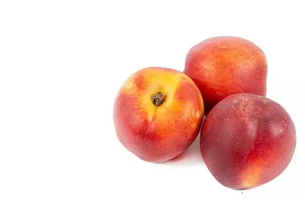 Fresh Peaches above white background