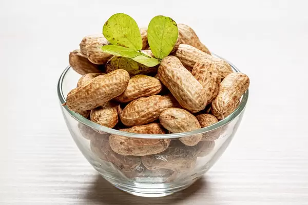 Fresh peanuts with shells in a glass bowl
