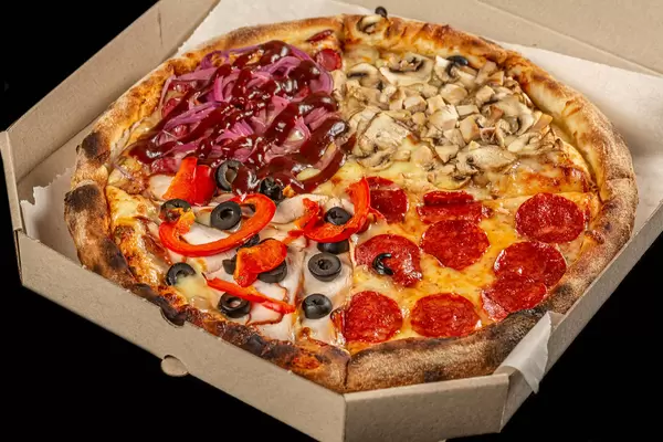 Fresh pizza four seasons in a cardboard box