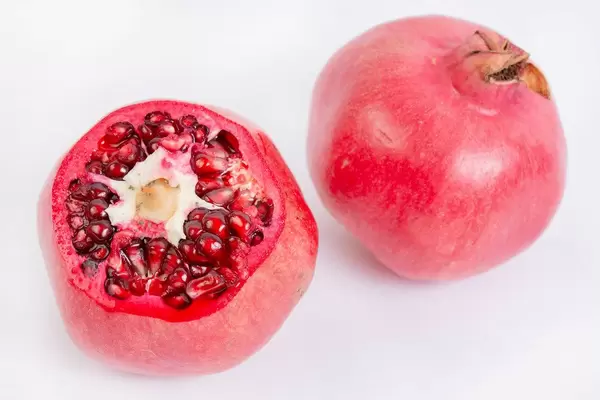 Fresh Pomegranate isolated above white background