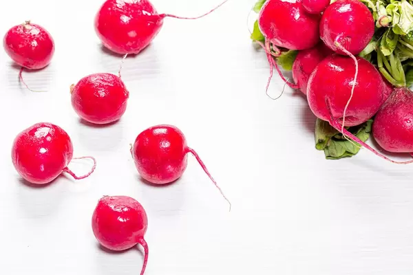 Fresh radish on white wooden background
