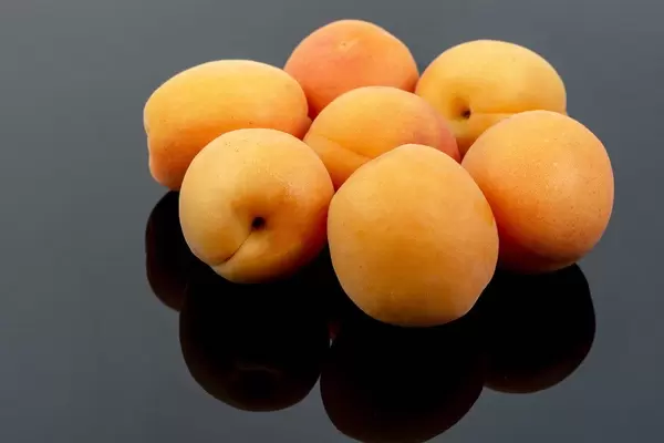 Fresh raw Apricots on the black background