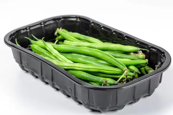 Fresh raw asparagus beans in a black container