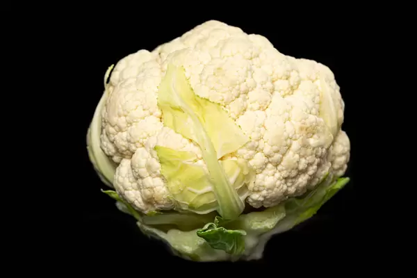 Fresh raw cauliflower on a dark background