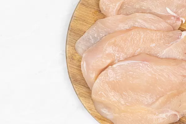 Fresh Raw Chicken meat on the wooden board with copy space