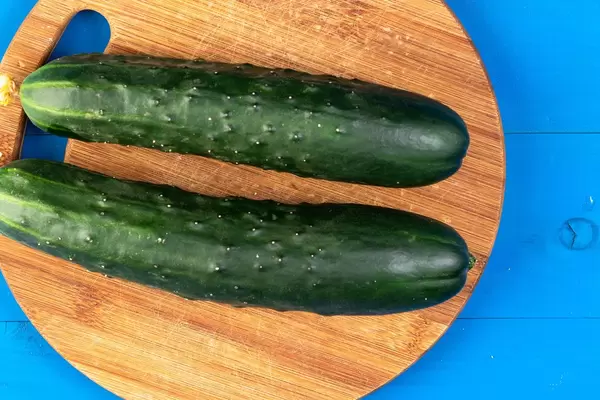 Fresh Raw Cucumber on the kitchen wooden board (Flip 2019)