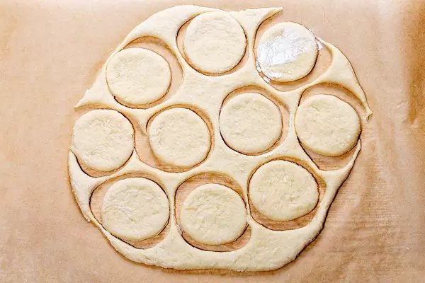 Fresh raw dough with the cut out circles. Top view (Flip 2019)