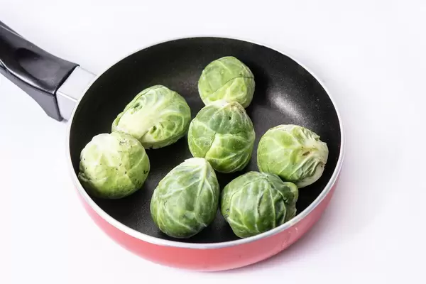 Fresh raw healthy Brussel Sprouts in the frying pan (Flip 2019)
