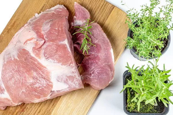 Fresh raw meat pork with rosemary and thyme
