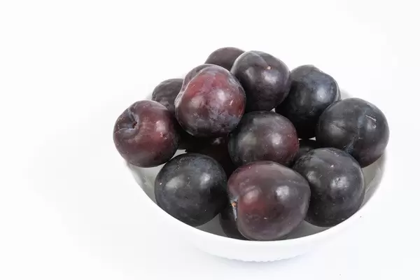 Fresh Raw Plums isolated above white background