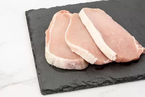 Fresh Raw Pork Chops on the stone tray