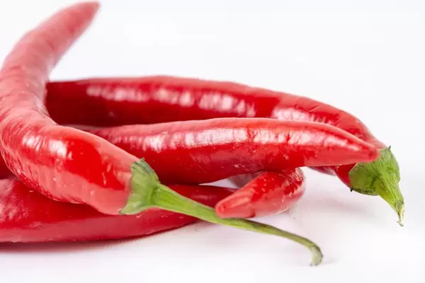 Fresh Red Hot Chilli Peppers above white background (Flip 2019)