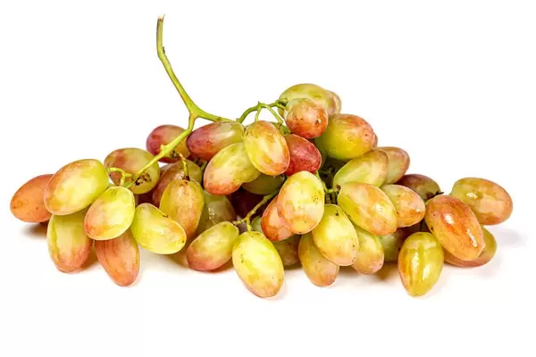 Fresh ripe branch of grapes on white