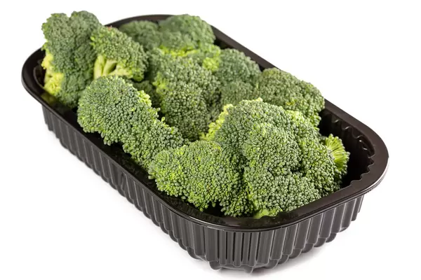 Fresh ripe broccoli in a black plastic container