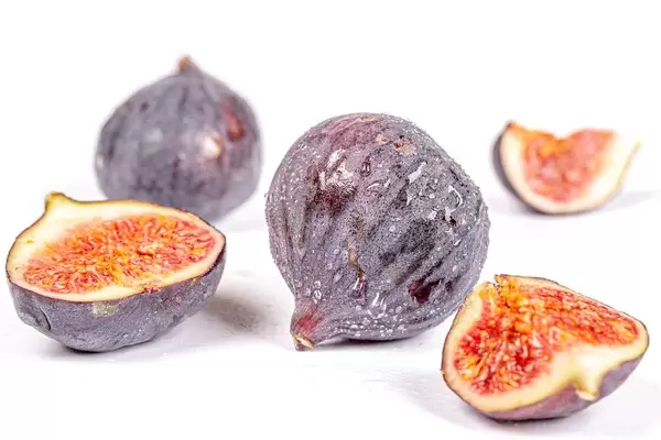 Fresh ripe figs on white background